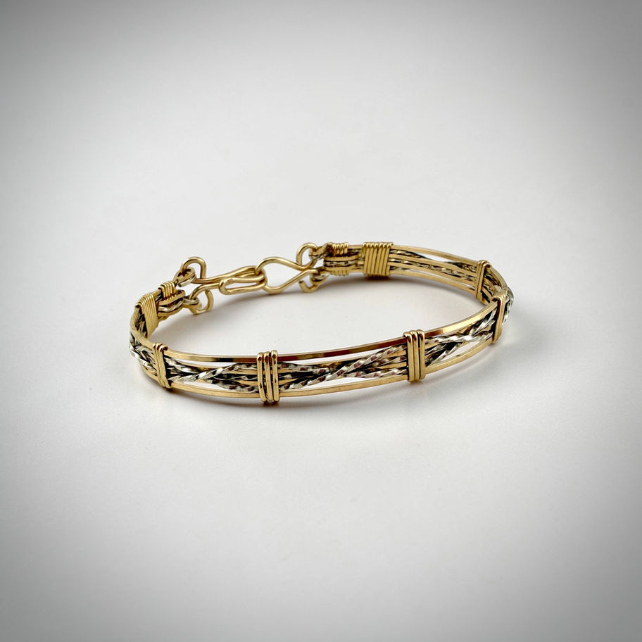 Front overview of Criss-Cross Bracelet showing sterling silver and rolled gold wrapped criss-cross design