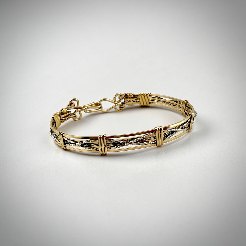 Front overview of Criss-Cross Bracelet showing sterling silver and rolled gold wrapped criss-cross design