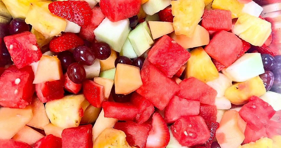 Close-up of a fruit salad with watermelon, pineapple, grapes, honeydew, and cantaloupe.
