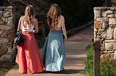 two women walkng across a bridge