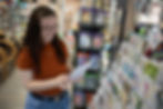 A happy customer shopping for greeting cards.