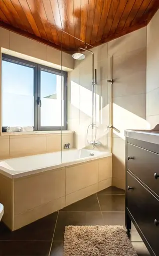 Blue Lake House's bathroom: tub, shower, toilet, and basin, window with a beautiful view of Lago Azul Marina, Castelo de Bode Lake, Ferreira do Zêzere.