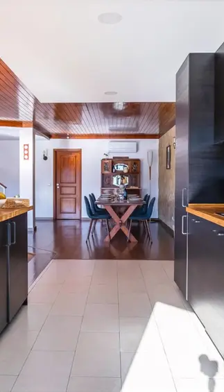 Blue Lake House's modern and spacious kitchen has an island and easy access to the large dinner table and living room.