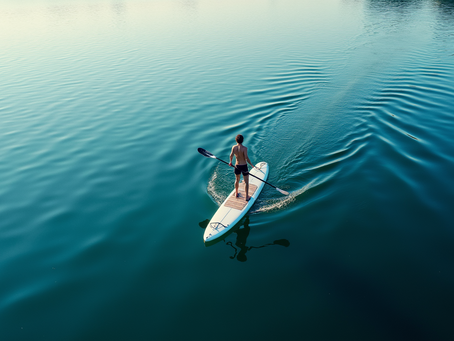 High angle view of a paddleboarder on calm Castelo do Bode Lake blue lake waters