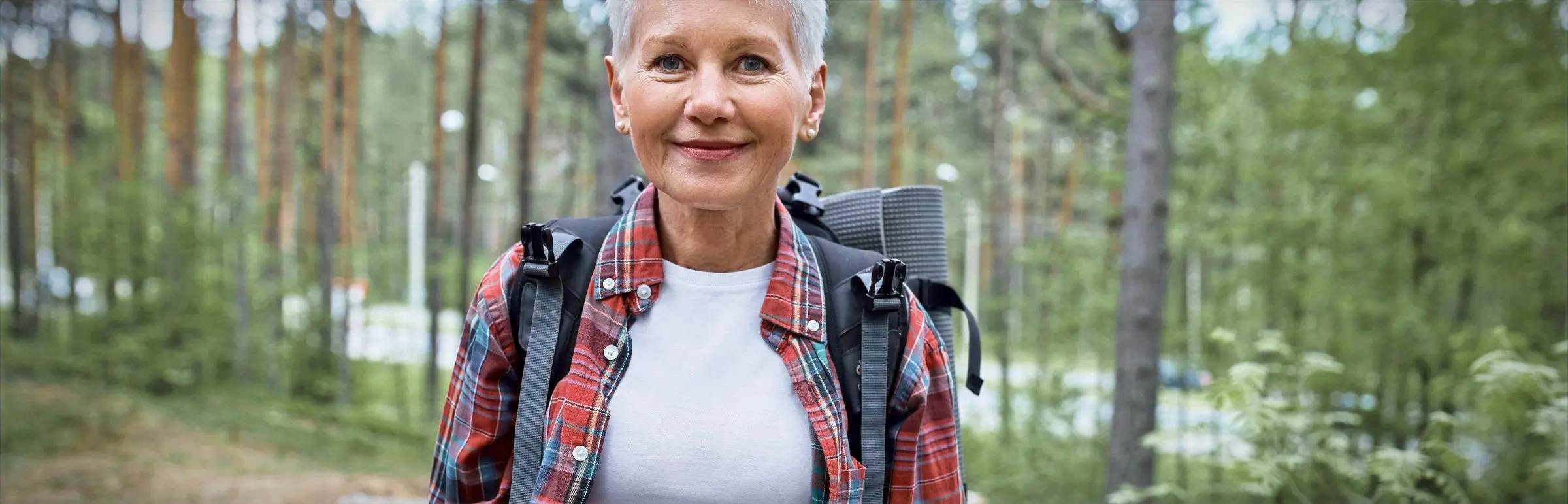 A senior woman hikes on the Castelo de Bode Lake trails in Ferreira do Zêzere, Portugal.