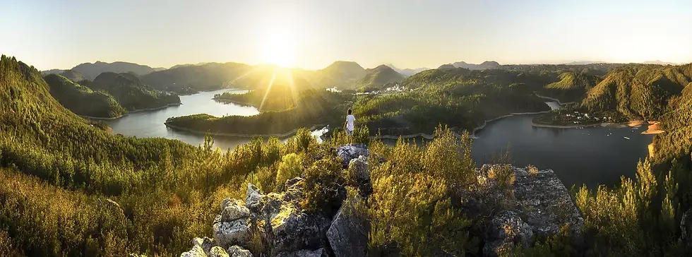 A girl watches the sunset overlooking Castelo de Bode Lake in Vila do Rei, Portugal.