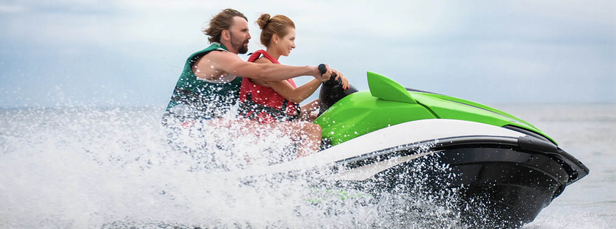 A young couple enjoys a jet ski ride at Castelo de Bode Lake, Ferreira do Zêzere, Portugal.