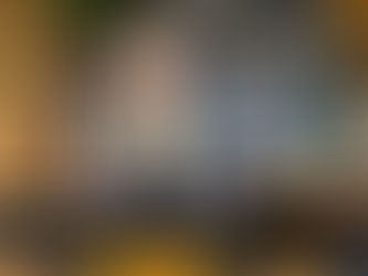 Tattooed person smiling in a cozy room with wooden decor. Text: "Tattoos You Don't Have to Explain (And Why That's Often the Point)." Logo: Loyal Sparrow.