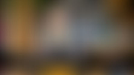 Tattooed person smiling in a cozy room with wooden decor. Text: "Tattoos You Don't Have to Explain (And Why That's Often the Point)." Logo: Loyal Sparrow.