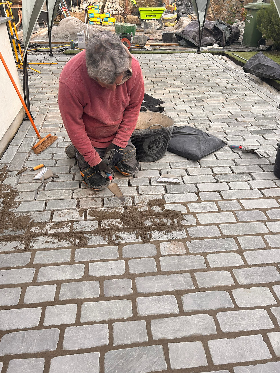 During works grouting between setts garden patio Mousehole