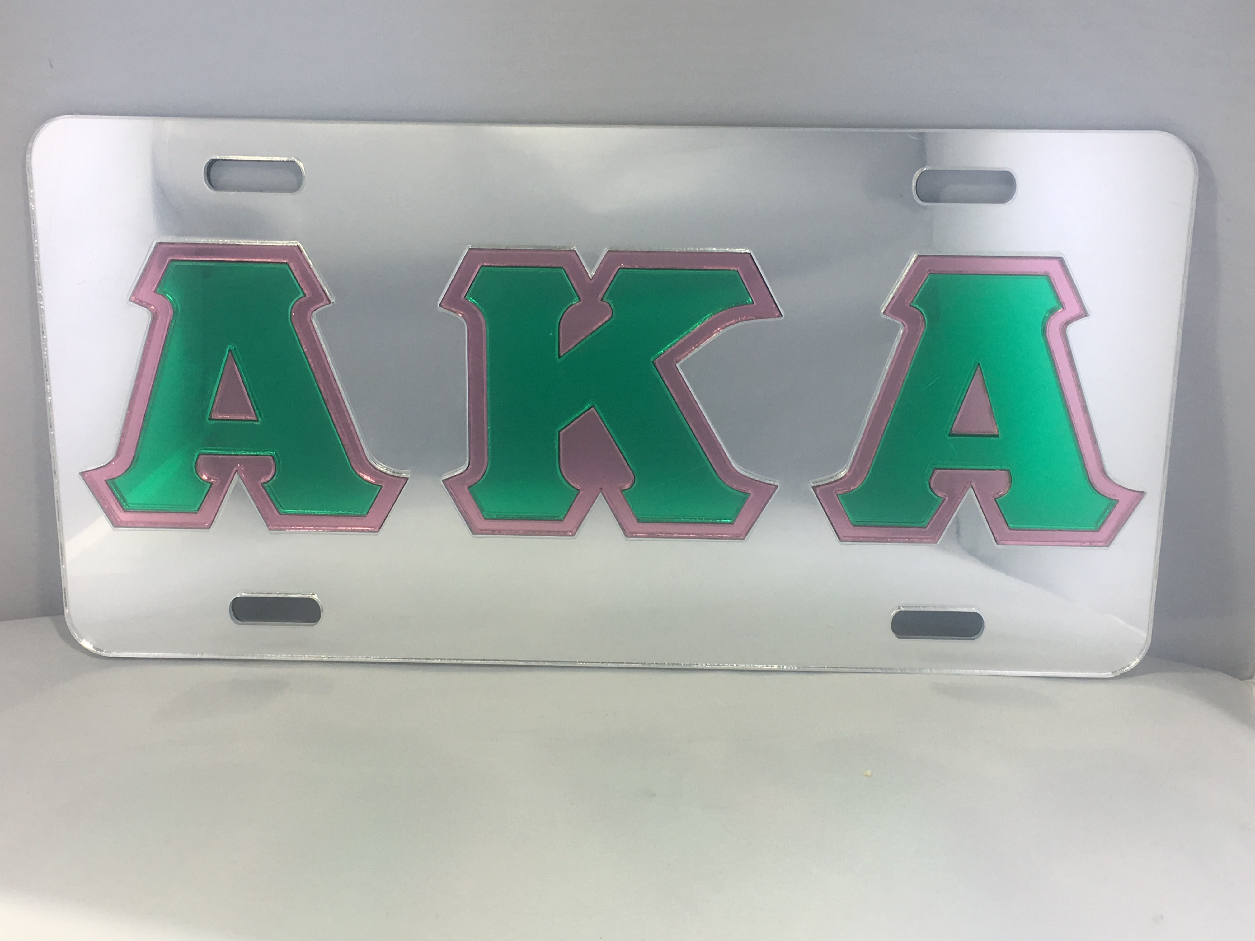 AKA License Plate- Mirror Background Green Letters Pink Outline