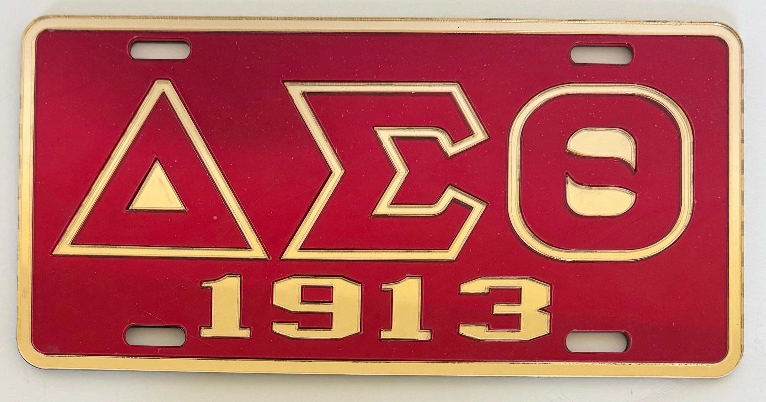 DST 1913 Tag- Red Background Gold Rim Gold Letters