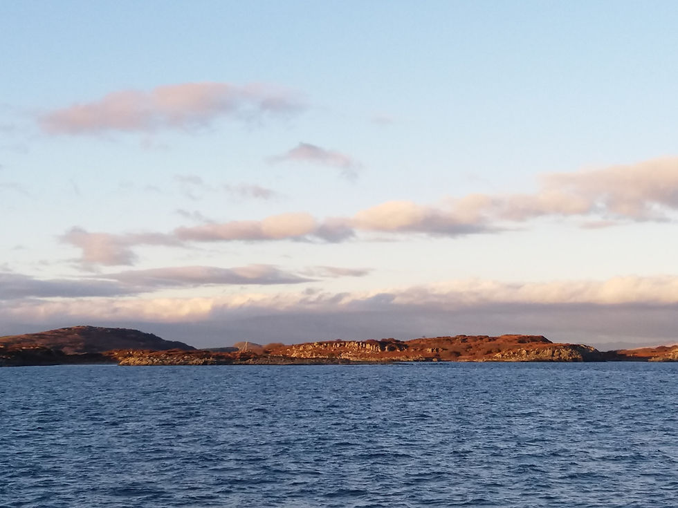 The vast sea with the long almost flat Isle of Gigha.