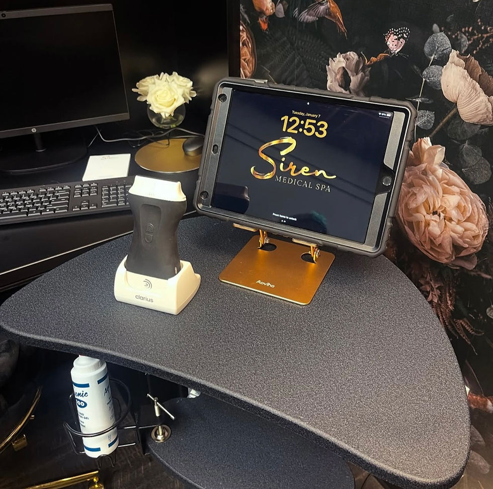Close-up of a hand holding a small mirror beside neutral skincare items.