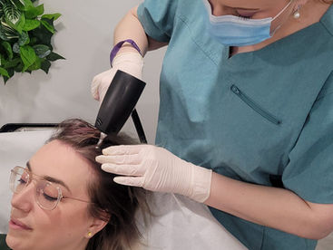Specialist performing Alma TED hair restoration treatment using ultrasound technology on a patient’s scalp