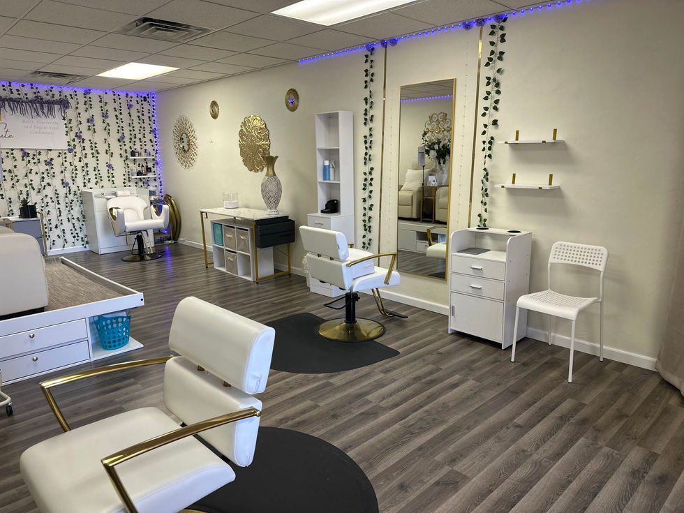 Salon interior with white chairs and modern decor.