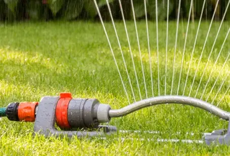 fan sprinkler watering residential lawn