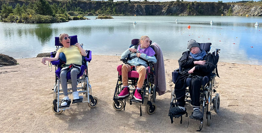 Three people we support from our residential lodges at the beach.