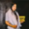 Woman holding The Curators snack packet