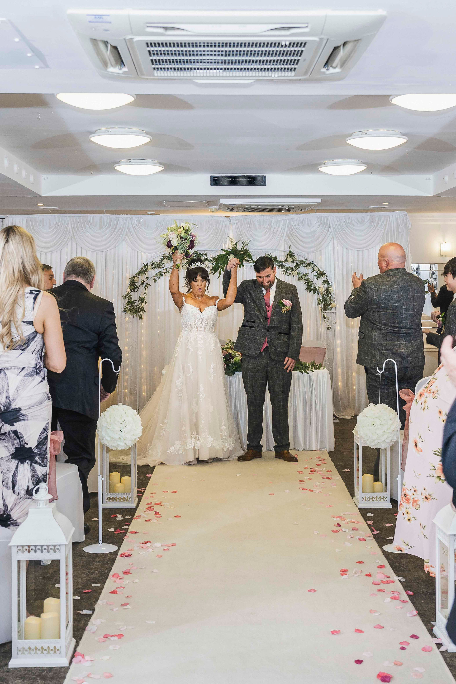 Sharon and Gary celebrating a joyful moment during their wedding ceremony.