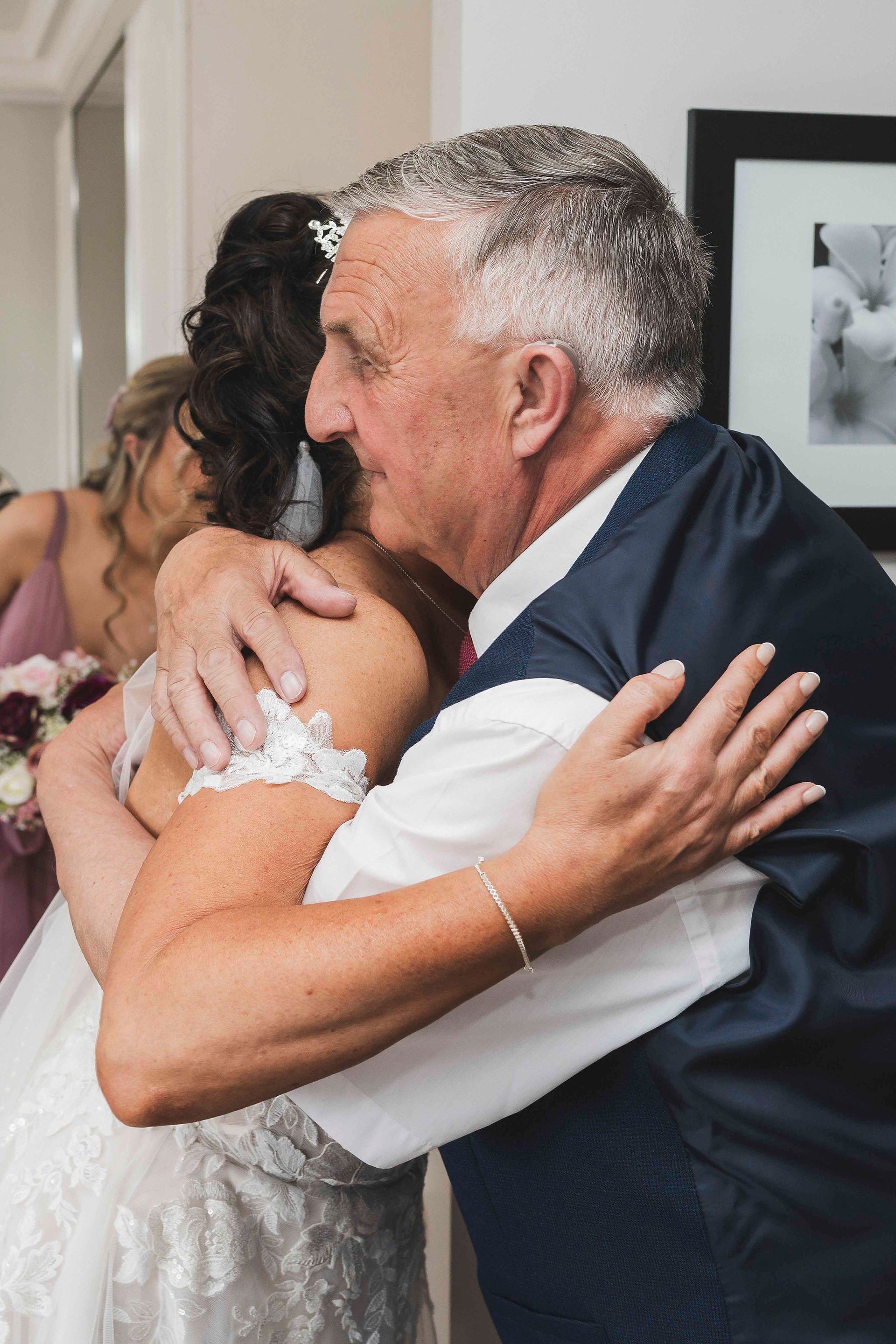 Sharon embracing her father during an emotional family moment.