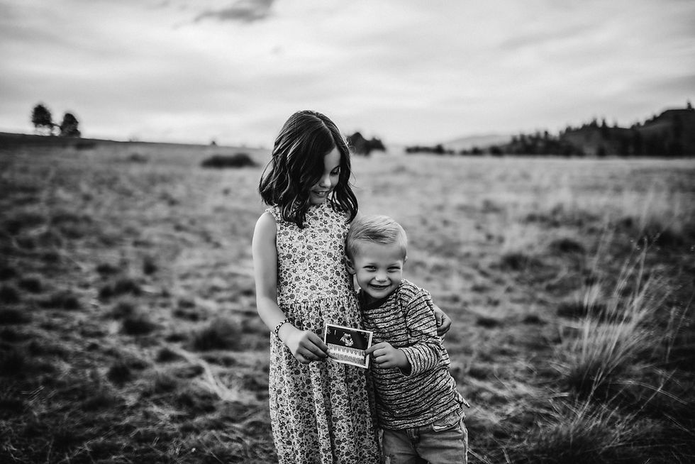 Family poses for their baby announcement session in Missoula, Montana, captured by Infinite Photography and Film