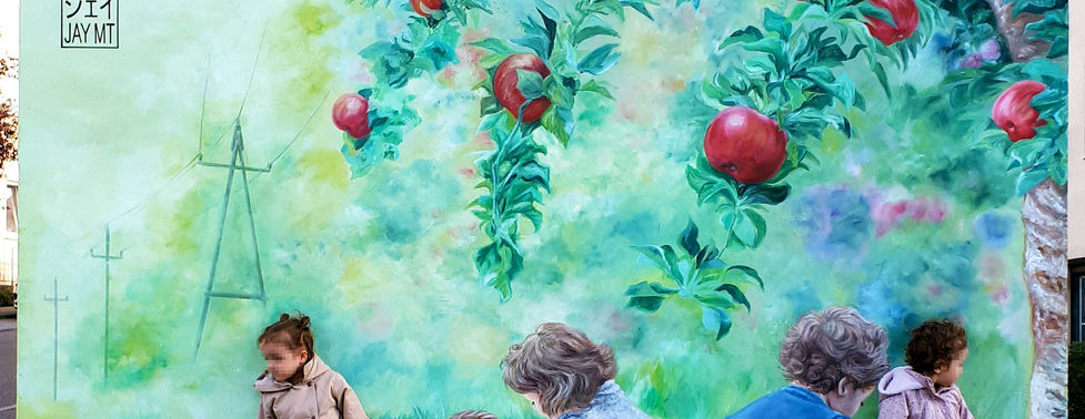 Children sitting in front of a colourful nature-inspired transformer station mural painted by JayMT & Silva for Netze BW in Bönnigheim, Baden-Württemberg, Germany.