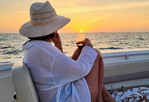 Woman sitting on a boat watching the sunset after Key West sandbar trips