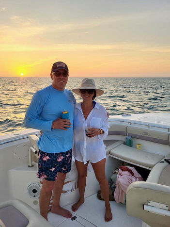 couple on a boat with the key west sunset