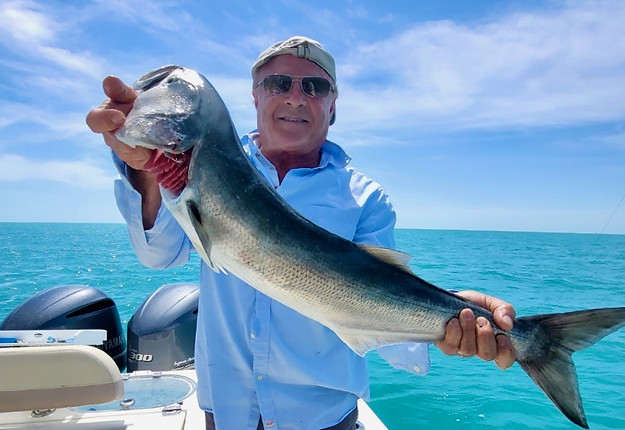 man holding a fish on Who D.A.T. fishing or Key West sandbar trips