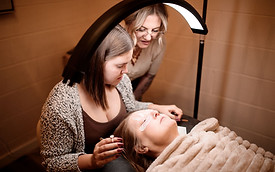 Mikaela and Carlee, spa technicians practicing lash extensions.