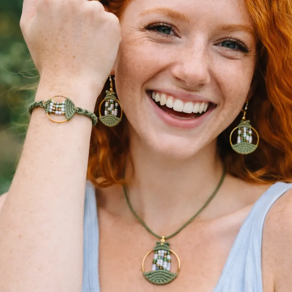 Femme portant la parure Lyren Vert Sauge en macramé avec collier, bracelet et boucles d’oreilles artisanales