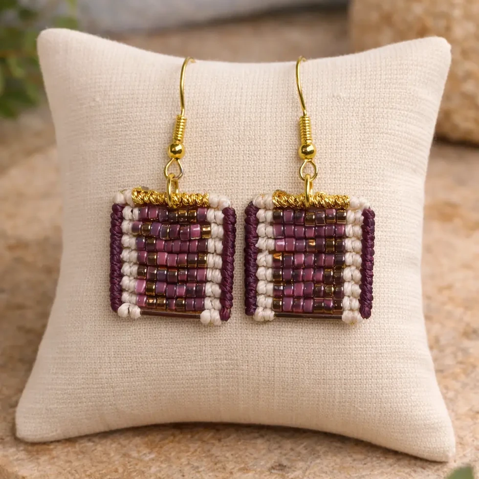 boucles d'oreilles tessare tissées macramé avec une mosaïque de perle bordeaux, doré sur un coussin