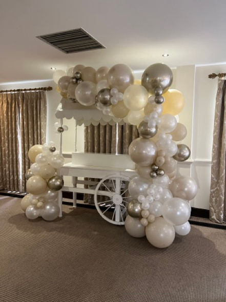 A balloon garland for the candy cart created by Confetti Party for the baby shower party in Cobham