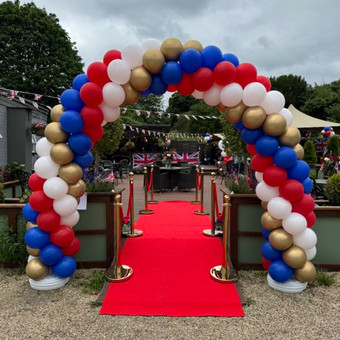 Classic balloon arch in blue, red, white, gold colours