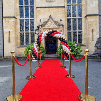 Balloon arch in red, black, white and gold colours