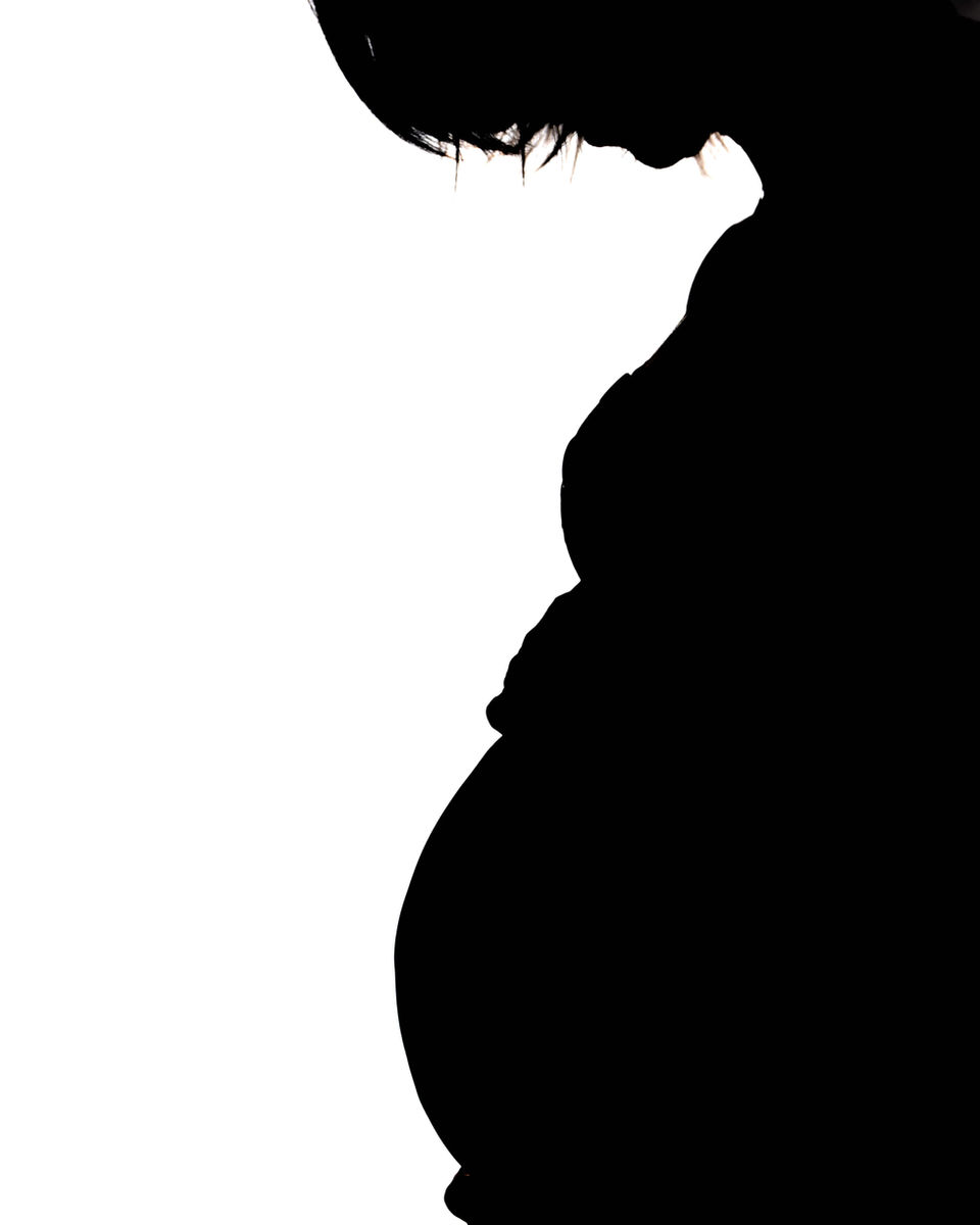 Gegenlicht Aufnahme mit hohem Kontrast einer schwangeren Frau