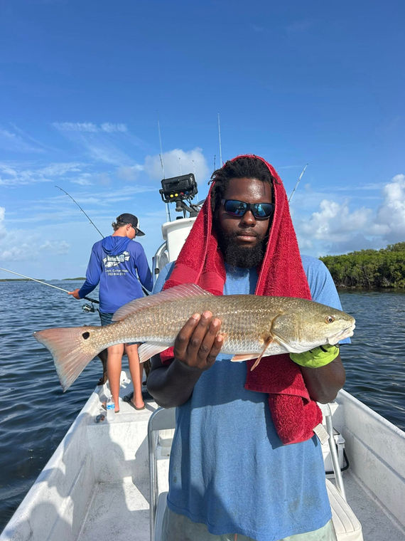 man holding brown fish
