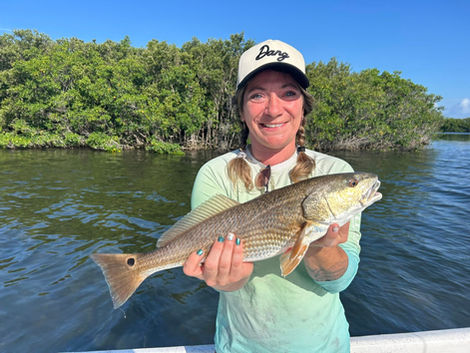 Smiling woman holding large redfish