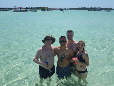 4 people standing in the water