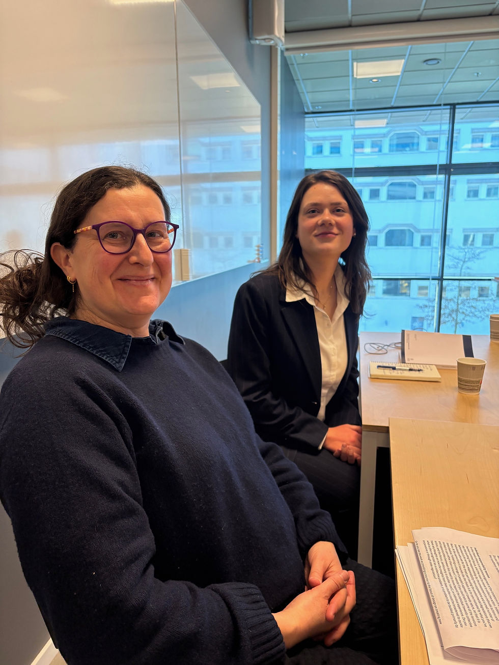 Sara and Patricia sit at a table 