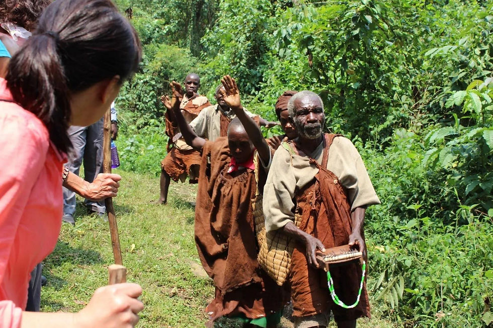 Tourist meeting Batwa people during a Bwindi safari.