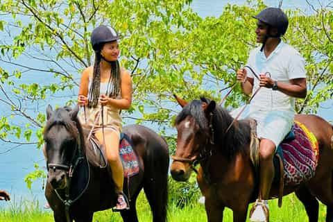 Couple horseback riding on a Jinja Adventure safari.