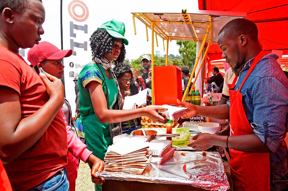 Street food vendor serving customers at an outdoor food tour.