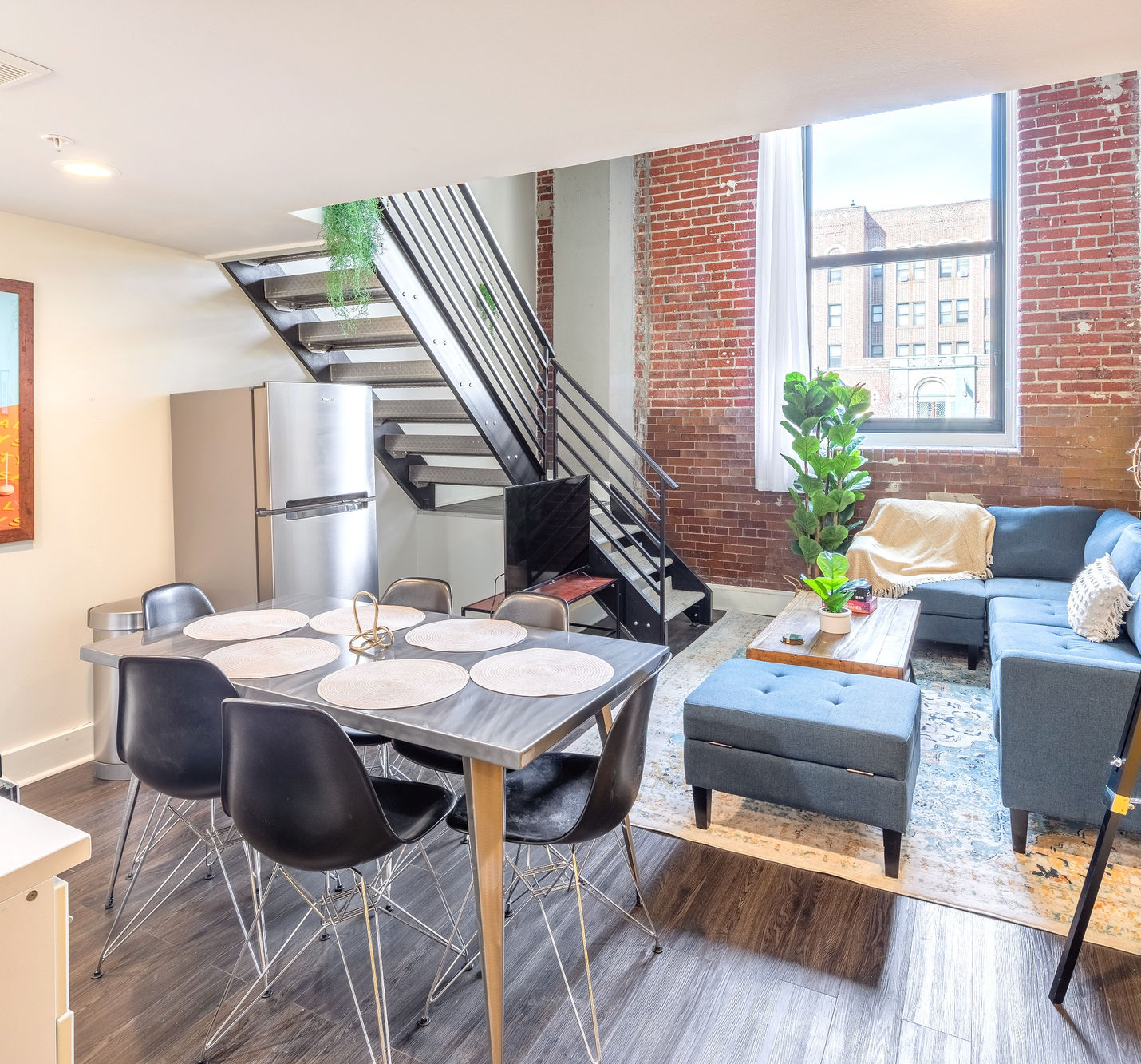 Partial view of dining and living room area from the kitchen of an apartment at West Lofts