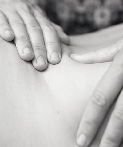 Close-up van masserende handen bij een natuurgeneeskundige behandeling