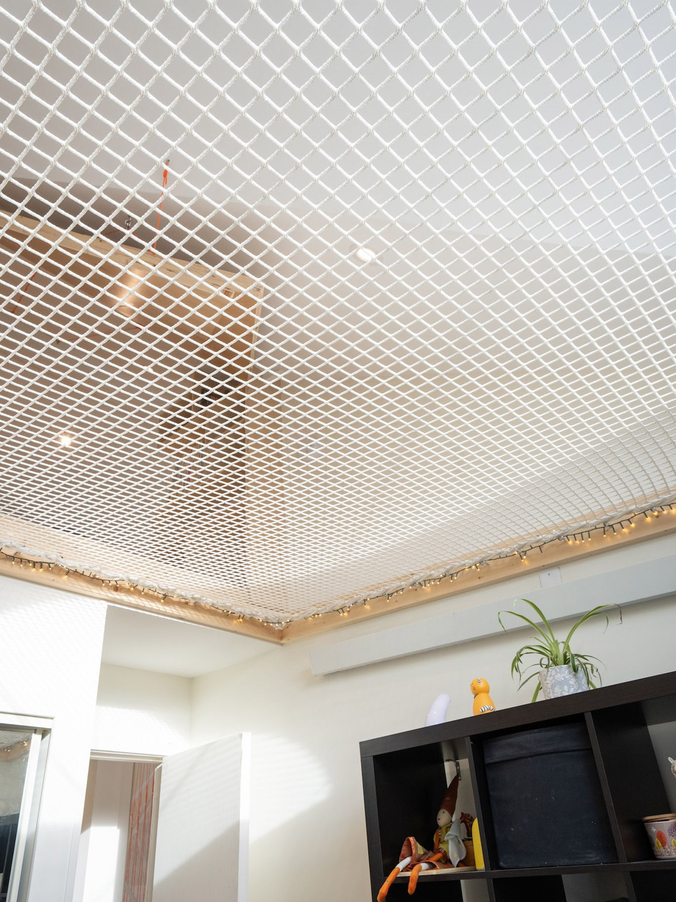 Overhead view of attic shelves and netted railing, showcasing an open and airy design perfect for a modern home