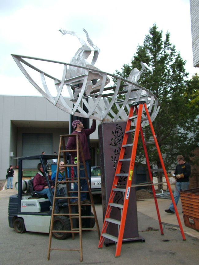 Ferris State University student working on The River Runs Through Us. Sculpture City