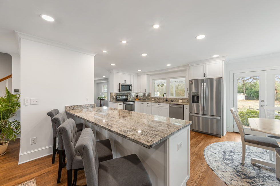 a kitchen with granite counter tops and stainless steel appliances