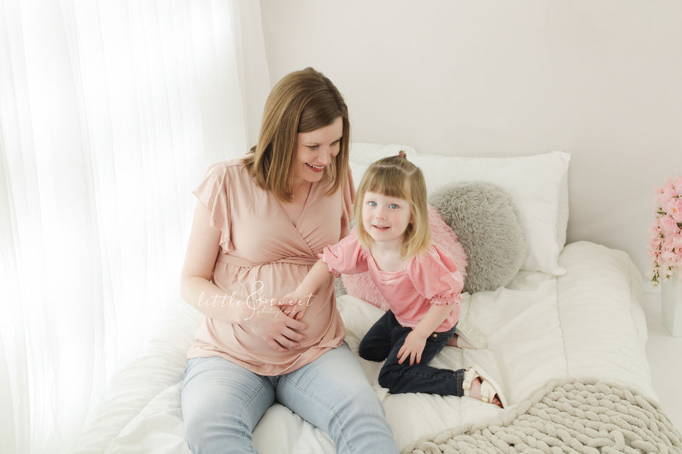 Mom and daughter in white bright studio